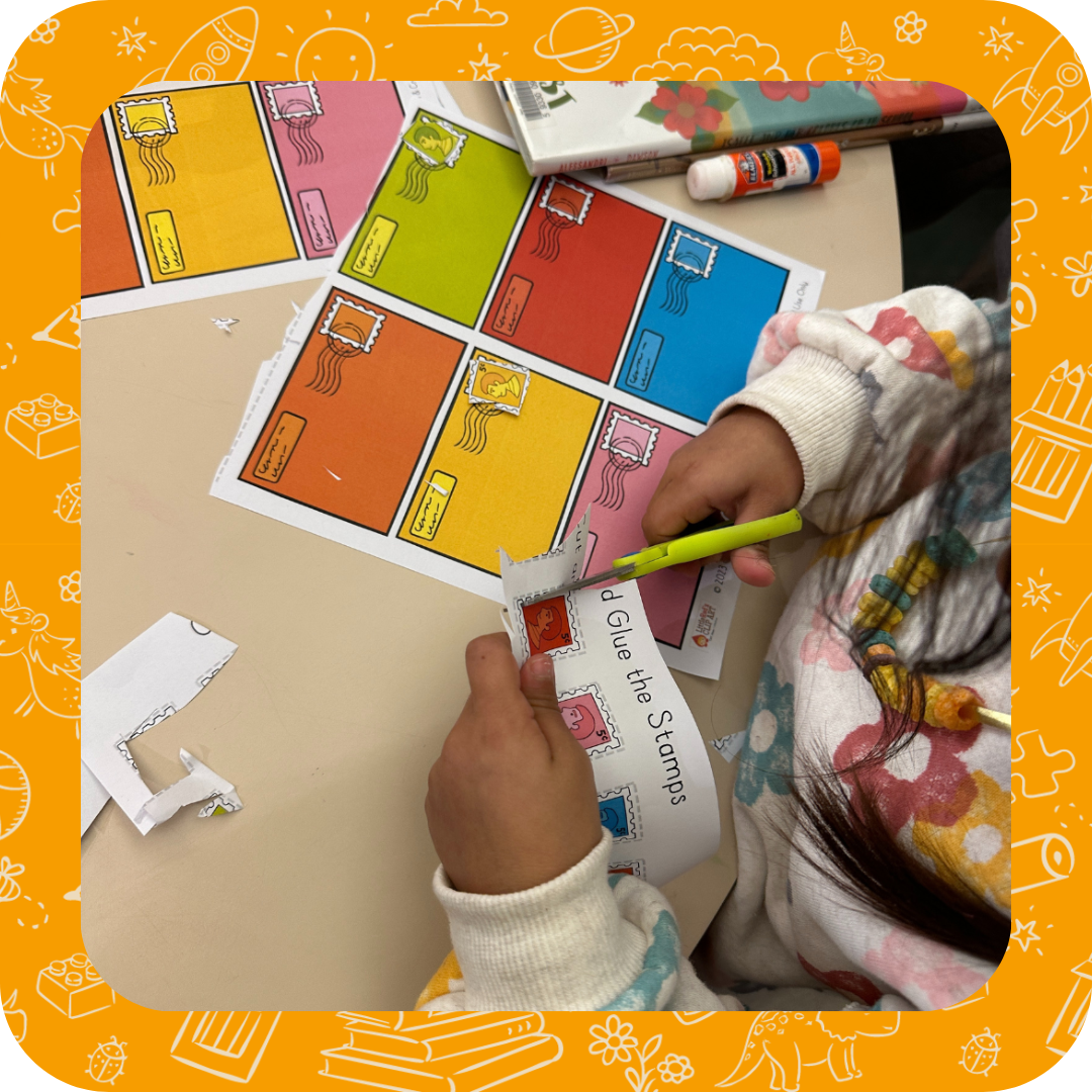 Child working on an activity using scissors and glue.