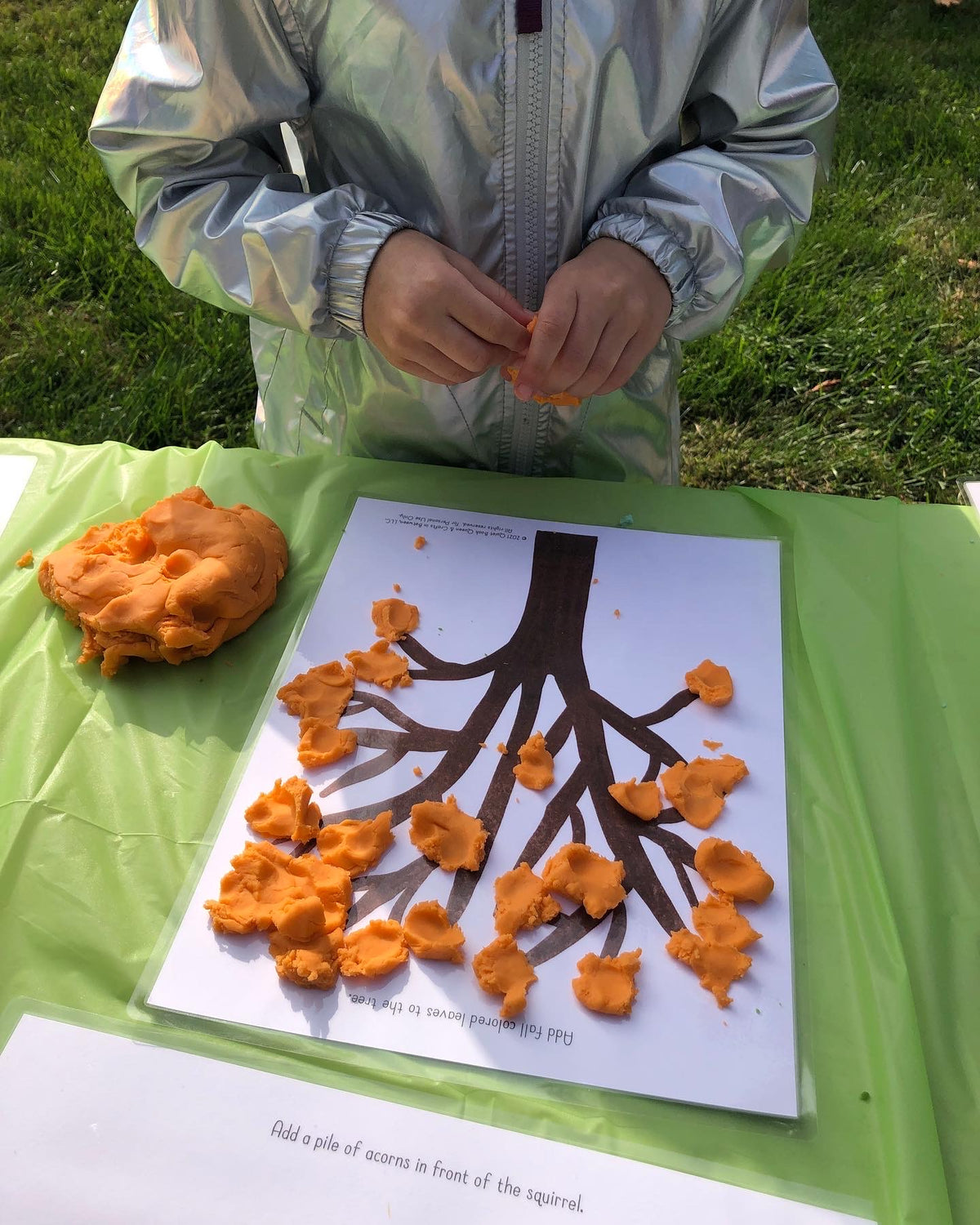 Child playing with a Play Dough Mat activity.
